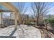 An outdoor stone patio space surrounded by a wooden fence and mature landscaping at 771 Park Manor Se Dr, Smyrna, GA 30082