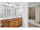 Well-lit bathroom featuring a double vanity, framed mirror, and a shower-tub combination at 771 Park Manor Se Dr, Smyrna, GA 30082