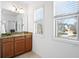 Bright bathroom features a granite countertop vanity and two windows overlooking the manicured lawn at 771 Park Manor Se Dr, Smyrna, GA 30082