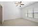 Bright bedroom with neutral carpet, ceiling fan, and window with privacy blinds at 771 Park Manor Se Dr, Smyrna, GA 30082