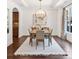 Bright dining room with backyard view, modern lighting and neutral color scheme at 771 Park Manor Se Dr, Smyrna, GA 30082