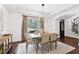 Charming dining room with an eye-catching chandelier, backyard view and stylish seating for four at 771 Park Manor Se Dr, Smyrna, GA 30082