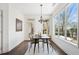 Sunlit dining room with modern lighting, large windows, and backyard views at 771 Park Manor Se Dr, Smyrna, GA 30082