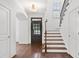 Bright foyer featuring hardwood stairs, a dark door, and white walls at 771 Park Manor Se Dr, Smyrna, GA 30082