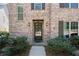 Close up of the front exterior featuring a brick facade, dark shutters and a covered front door at 771 Park Manor Se Dr, Smyrna, GA 30082