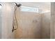 Modern tiled shower features an adjustable shower head, a built-in niche, and a window for natural light at 771 Park Manor Se Dr, Smyrna, GA 30082
