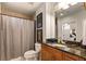 Granite vanity and shower/tub combo in this well-appointed bathroom with a view into the Primary bedroom at 855 Peachtree St # 2901, Atlanta, GA 30308