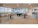 Bright game room with a billiard table, bar-height seating and city views through large windows at 855 Peachtree St # 2901, Atlanta, GA 30308
