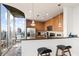 Bright kitchen with stainless steel appliances, and breakfast bar with city views through floor-to-ceiling windows at 855 Peachtree St # 2901, Atlanta, GA 30308