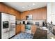 Kitchen featuring stainless steel appliances, wood cabinetry, and granite countertops at 855 Peachtree St # 2901, Atlanta, GA 30308