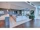 Open-concept living room featuring tile floors, a sectional couch, and access to an outdoor patio space at 855 Peachtree St # 2901, Atlanta, GA 30308