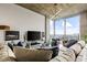 Living room features a modern light fixture, floor-to-ceiling windows, and comfortable, neutral-toned furniture at 855 Peachtree St # 2901, Atlanta, GA 30308