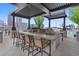 Rooftop grill area with bar stool seating, offering city views and a glimpse of the pool at 855 Peachtree St # 2901, Atlanta, GA 30308