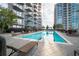 Outdoor swimming pool surrounded by lounge chairs, landscaping, and upscale high-rise buildings at 855 Peachtree St # 2901, Atlanta, GA 30308