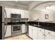Modern kitchen featuring stainless steel appliances, granite countertops, and white cabinetry at 1225 Westchester Ne Rdg, Atlanta, GA 30329