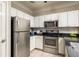 Efficient kitchen with stainless steel appliances, white cabinets, and a sleek design at 1225 Westchester Ne Rdg, Atlanta, GA 30329