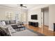 Inviting living room features hardwood floors, large windows, and a comfortable sectional sofa at 1225 Westchester Ne Rdg, Atlanta, GA 30329