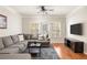 Cozy living room with hardwood floors, large windows, and a comfy sectional sofa at 1225 Westchester Ne Rdg, Atlanta, GA 30329