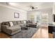 Stylish living room features a large sectional, hardwood floors, and modern TV console at 1225 Westchester Ne Rdg, Atlanta, GA 30329