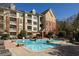 Relaxing swimming pool surrounded by sun loungers and lush landscaping at a beautiful multi-story complex at 1225 Westchester Ne Rdg, Atlanta, GA 30329