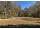 Expansive grassy field surrounded by trees, offering a serene outdoor space at 1225 Westchester Ne Rdg, Atlanta, GA 30329