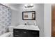 Bathroom with marble countertops, patterned shower curtain and silver fixtures at 2375 Justine Ter, Lithia Springs, GA 30122