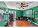 This bedroom features green walls, a ceiling fan, and beautiful hardwood floors at 2375 Justine Ter, Lithia Springs, GA 30122
