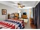 Bedroom featuring hardwood floors, ceiling fan, and an attached bathroom at 2375 Justine Ter, Lithia Springs, GA 30122