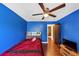 Bedroom featuring hardwood floors, a ceiling fan, and a plush red comforter at 2375 Justine Ter, Lithia Springs, GA 30122