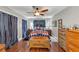 Cozy bedroom with hardwood floors, ceiling fan, and decorative furnishings at 2375 Justine Ter, Lithia Springs, GA 30122