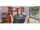 Elegant dining area with hardwood floors, round table, and a view of the backyard through sliding doors at 2375 Justine Ter, Lithia Springs, GA 30122