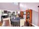 Eat-in kitchen and dining area with dark wood floors, display cabinets, and stainless steel appliances at 2375 Justine Ter, Lithia Springs, GA 30122