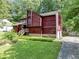 Beautiful wood home featuring an attached two-car garage and a lush green yard at 2375 Justine Ter, Lithia Springs, GA 30122