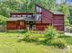Charming exterior of home with red wood paneling, large windows, and a well-maintained front yard at 2375 Justine Ter, Lithia Springs, GA 30122