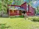 Charming exterior of home with red wood paneling, large windows, and a well-maintained front yard at 2375 Justine Ter, Lithia Springs, GA 30122