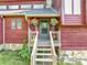 Covered front porch with decorative plants, wood railing and steps that leads up to the front door at 2375 Justine Ter, Lithia Springs, GA 30122