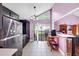 Open concept kitchen with sliding glass doors to the backyard, stainless appliances and light tile flooring at 2375 Justine Ter, Lithia Springs, GA 30122