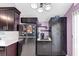 Kitchen with stainless steel appliances, dark wood cabinets, and modern lighting at 2375 Justine Ter, Lithia Springs, GA 30122