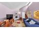 Bright living room with tall ceilings, fireplace, hardwood floors, and natural light from large windows at 2375 Justine Ter, Lithia Springs, GA 30122