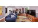 Open-concept living room with hardwood floors and a large window, adjacent to a dining area at 2375 Justine Ter, Lithia Springs, GA 30122