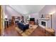 Comfortable living room with wood floors, fireplace, and large windows for natural light at 2375 Justine Ter, Lithia Springs, GA 30122
