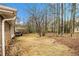 Wide view of the backyard, with a deck and wood fence in the background at 405 Putting Green Ln, Roswell, GA 30076