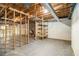 Unfinished basement featuring exposed wood beams and a brick fireplace at 405 Putting Green Ln, Roswell, GA 30076