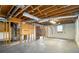 Unfinished basement featuring exposed wood beams, concrete floors, and a small window at 405 Putting Green Ln, Roswell, GA 30076
