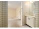 Bathroom featuring a white vanity and wallpaper at 405 Putting Green Ln, Roswell, GA 30076