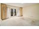 Bright bedroom with carpet, double doors to a balcony, and neutral paint at 405 Putting Green Ln, Roswell, GA 30076