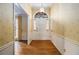 Welcoming entryway with hardwood floors, elegant wallpaper, and a classic front door at 405 Putting Green Ln, Roswell, GA 30076