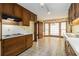 Eat-in kitchen features wooden cabinetry, white countertops, and floral wallpaper at 405 Putting Green Ln, Roswell, GA 30076