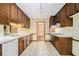Galley kitchen featuring wood cabinets, white countertops, and patterned flooring at 405 Putting Green Ln, Roswell, GA 30076