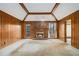 Spacious living room with wood paneled walls, a cozy fireplace, and outdoor views at 405 Putting Green Ln, Roswell, GA 30076
